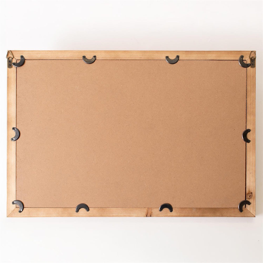 The back of a rectangular wooden picture frame with a brown cardboard backing and black metal swivel tabs.