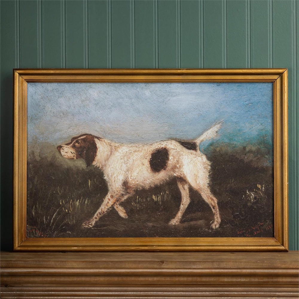 Framed oil painting of a white and brown pointer dog in a field under a blue sky.