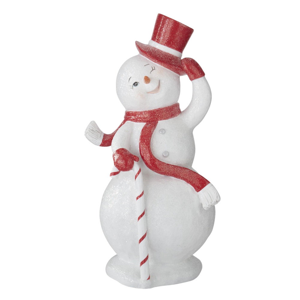 Front view of a white glittered resin snowman wearing a red top hat and holding a walking stick.