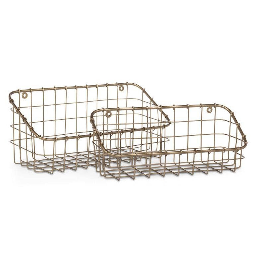 Set of two wall-mounted antique brass wire storage baskets isolated on a white background.