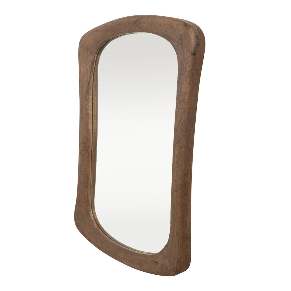 Organic shaped wall mirror featuring a hand-carved mango wood frame with a rich walnut finish in a vertical orientation.
