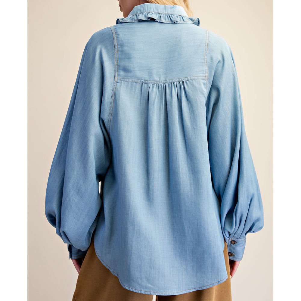 Rear view of light blue washed denim chambray shirt showing a ruffled collar and gathered yoke.