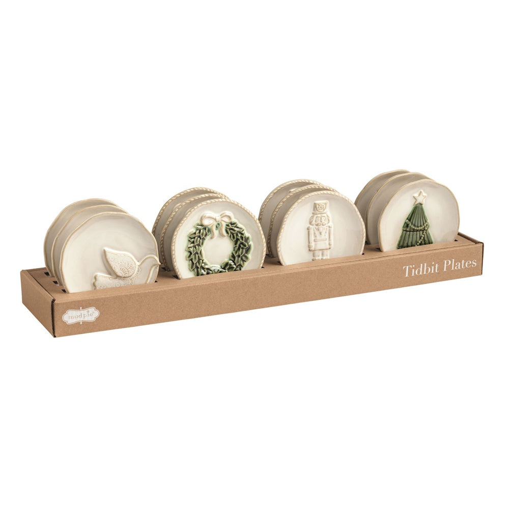 Retail cardboard display box holding organized rows of ceramic holiday tidbit plates.