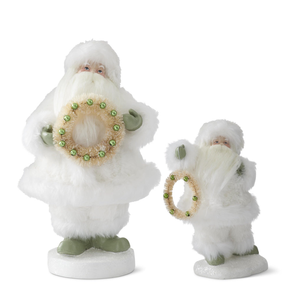 Set of 2 Santa figurines wearing white faux fur suits and holding bottlebrush wreaths with green ornaments.