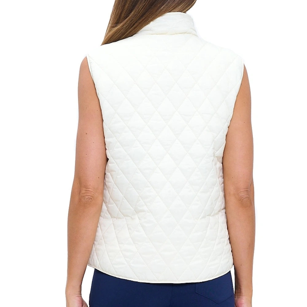 Back view of a woman wearing a white diamond-quilted vest with a high collar and navy pants.