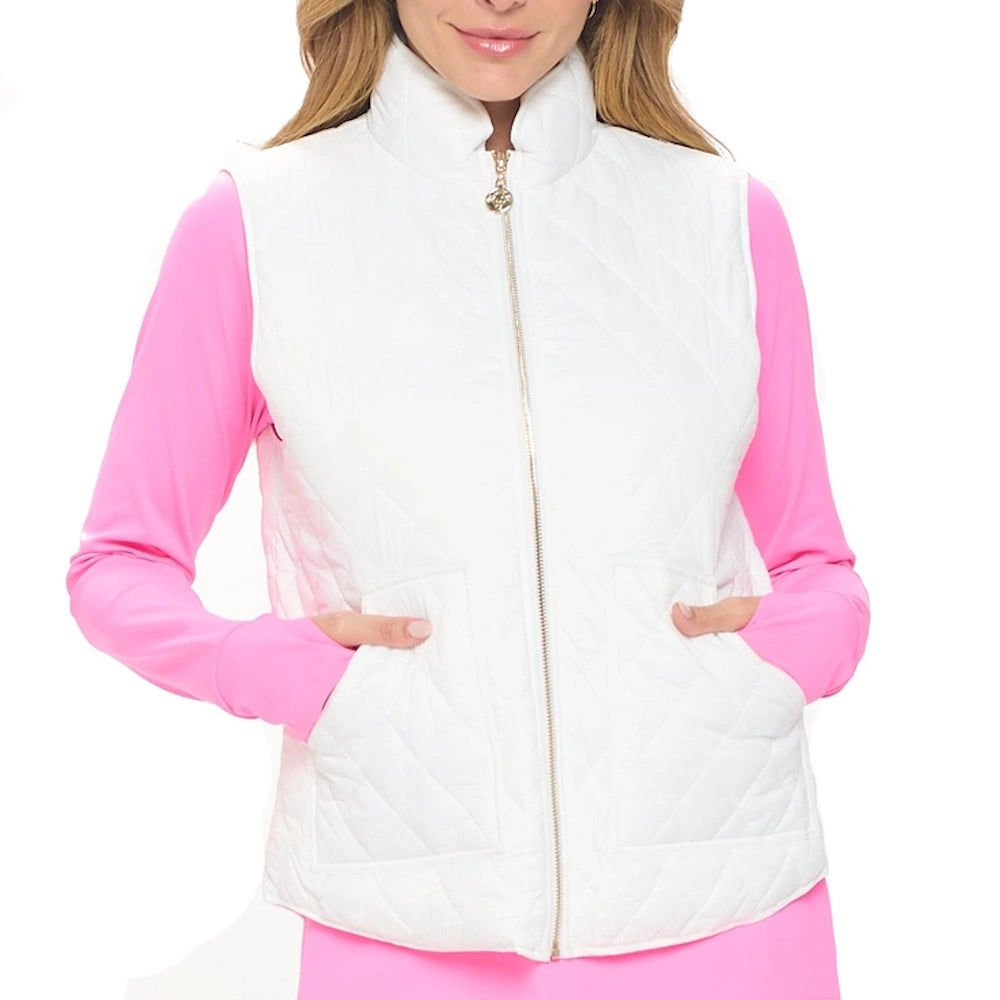 Woman wearing a white diamond-quilted zip-up vest over a pink long-sleeve shirt.
