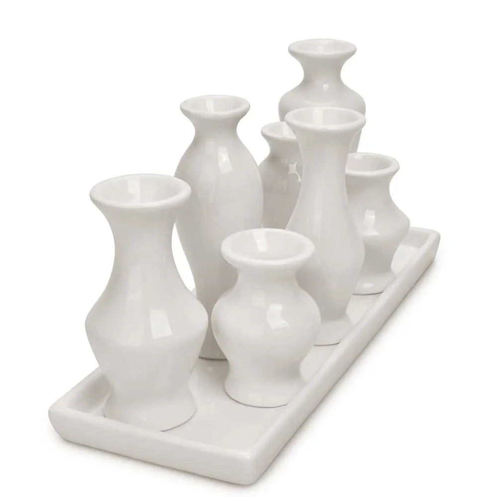 White ceramic bud vase set on a matching tray shown from an angled side view.