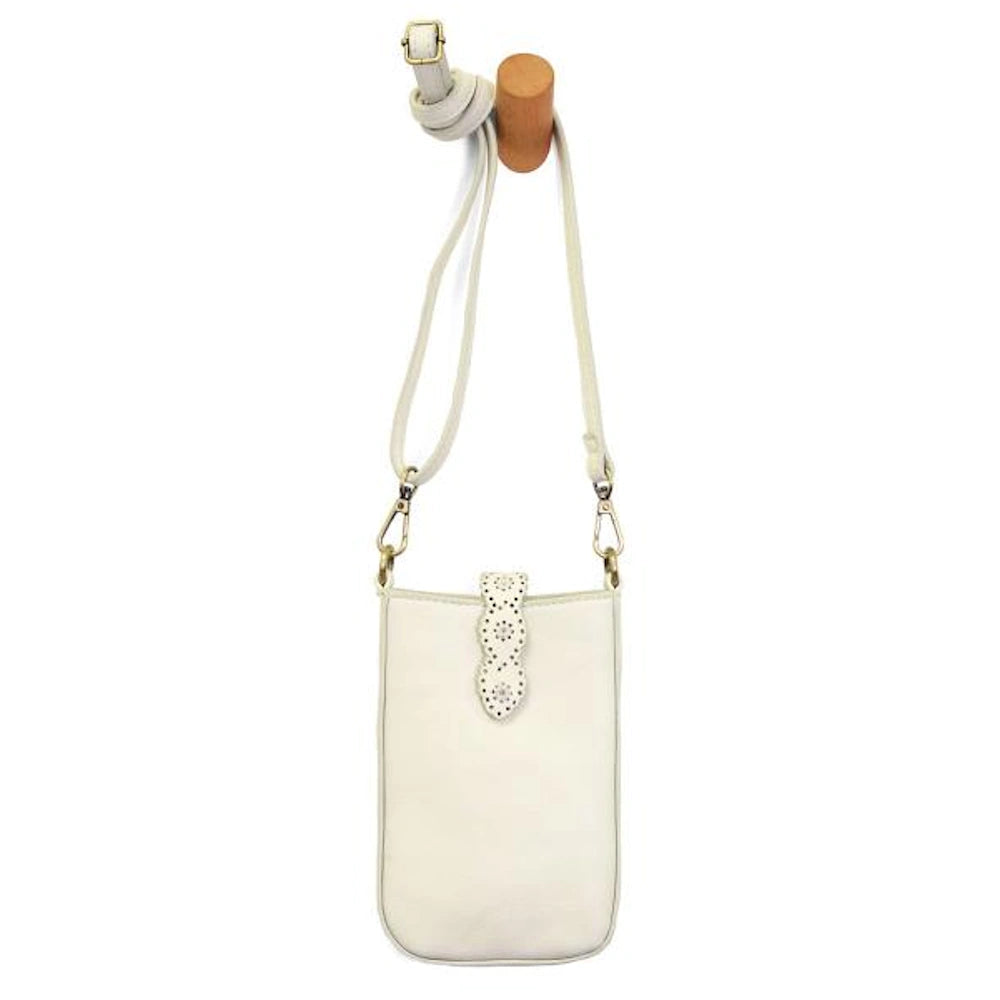 White laser-cut daisy phone crossbody bag with a long strap hanging from a wooden peg on a white background.