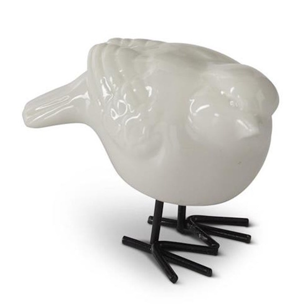 White porcelain bird figurine with minimalist black wire legs on a white background for home decor.