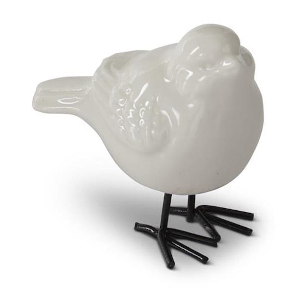 White porcelain bird figurine with black metal feet and a glossy finish, facing right on a plain white background.