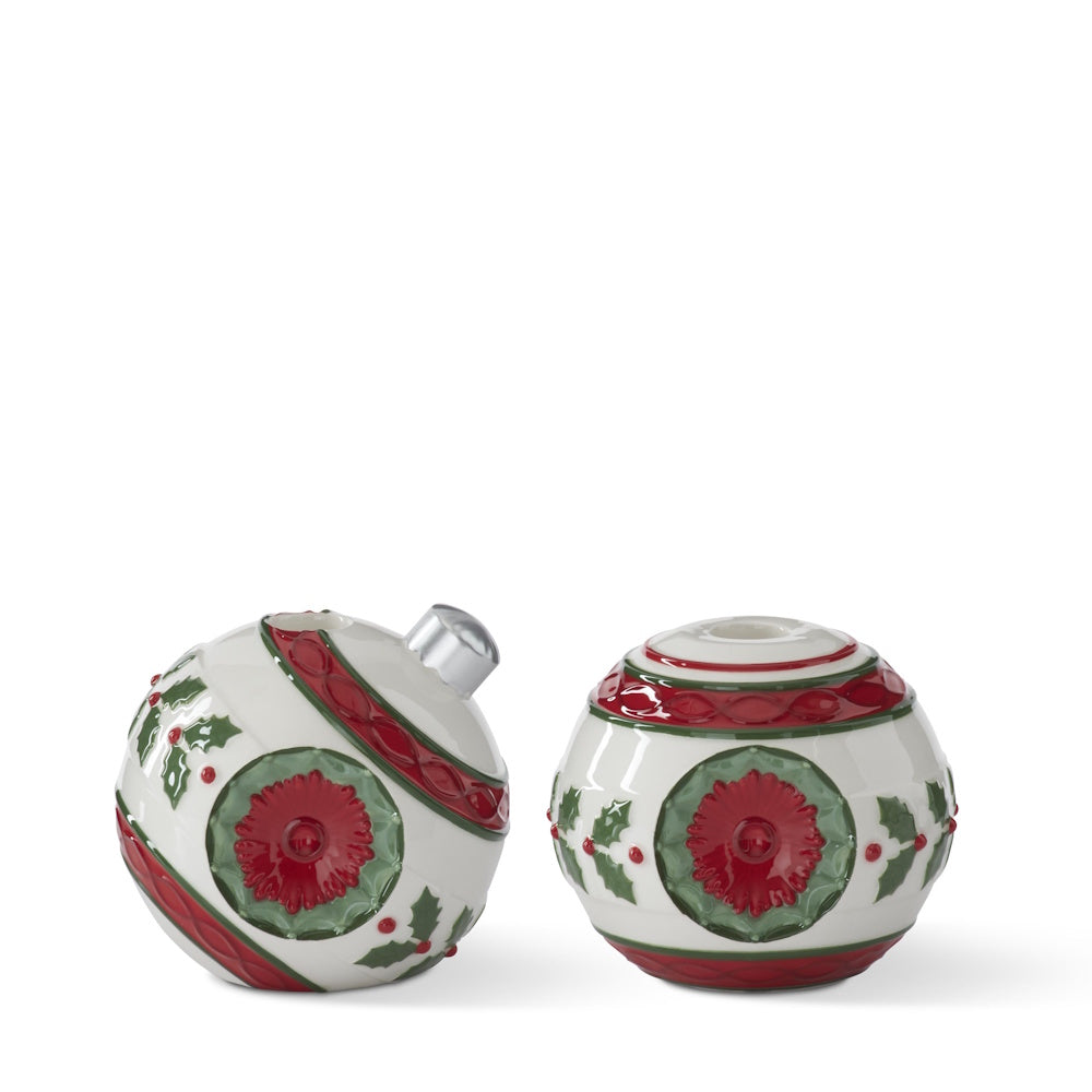 White and red ceramic ornament-shaped taper candleholders with green holly and berry details.