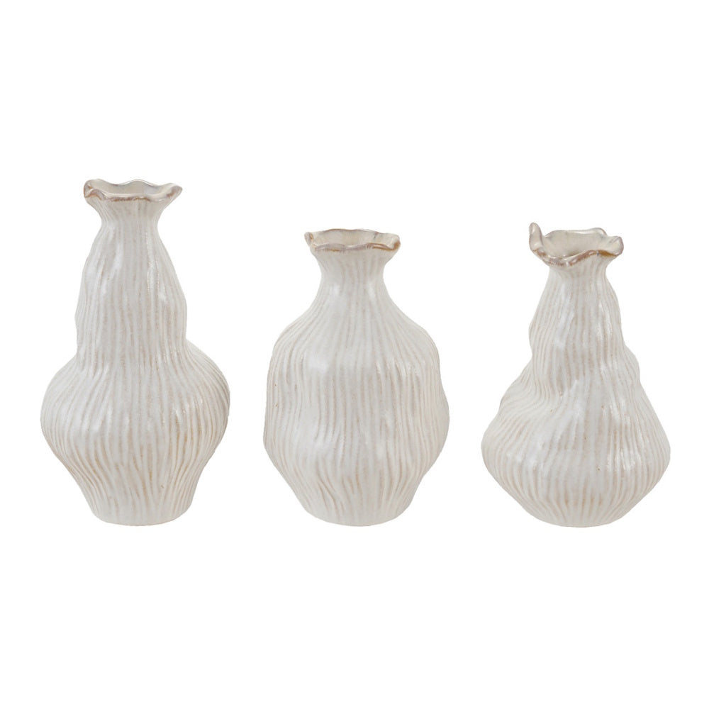 Three white, organic-shaped stoneware vases with vertical textures and ruffled rims on white background.