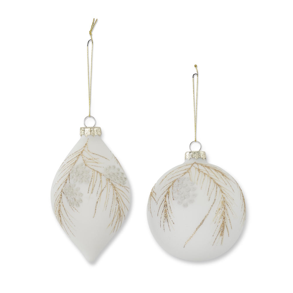 Two white glass Christmas ornaments decorated with gold glitter pine needles and pinecones.