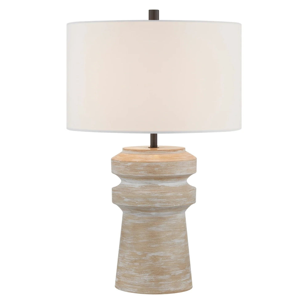 Natural wood table lamp with distressed sculpted base, white drum shade and dark metal accents.