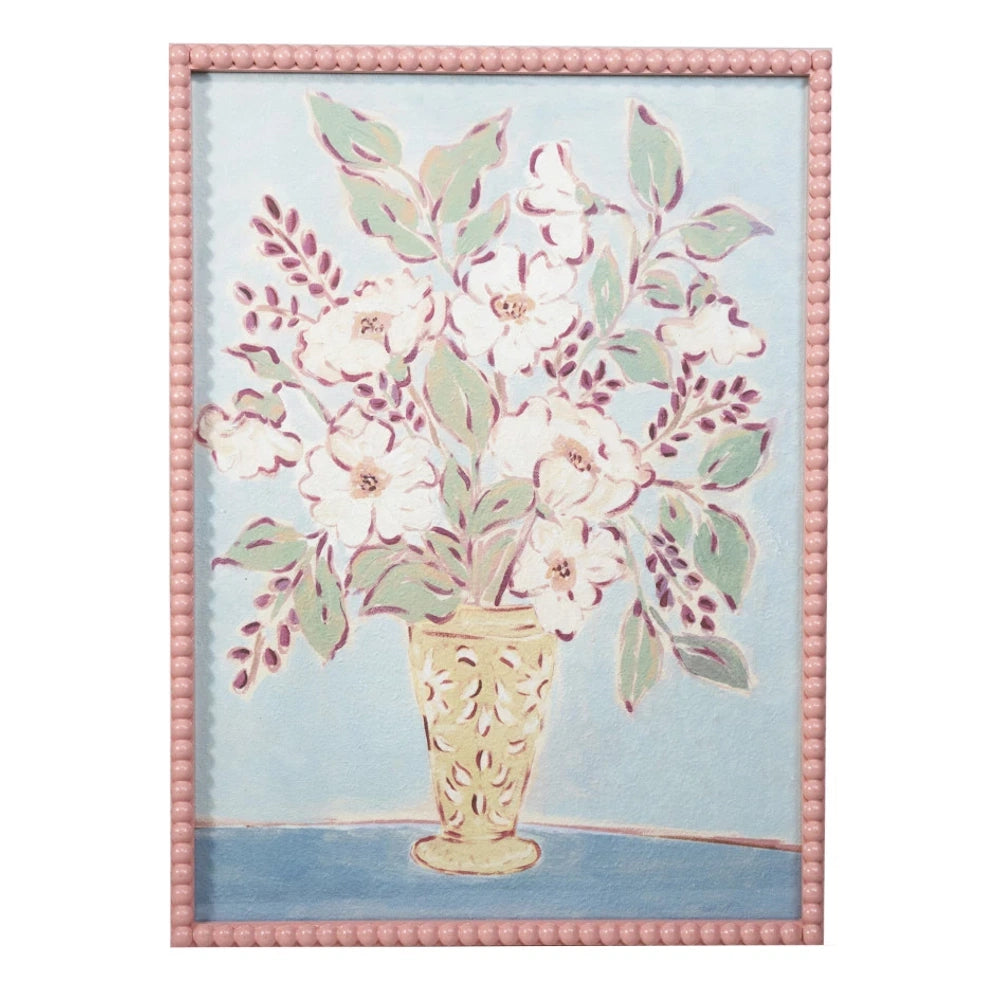 Framed floral still life painting of white flowers in a yellow vase with a pink beaded border.