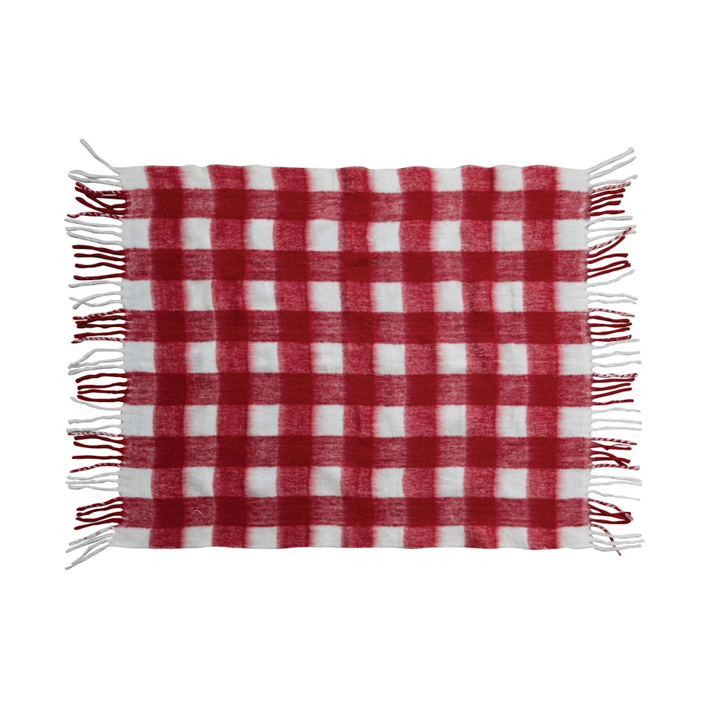 Red and white plaid woven throw blanket with fringed edges.