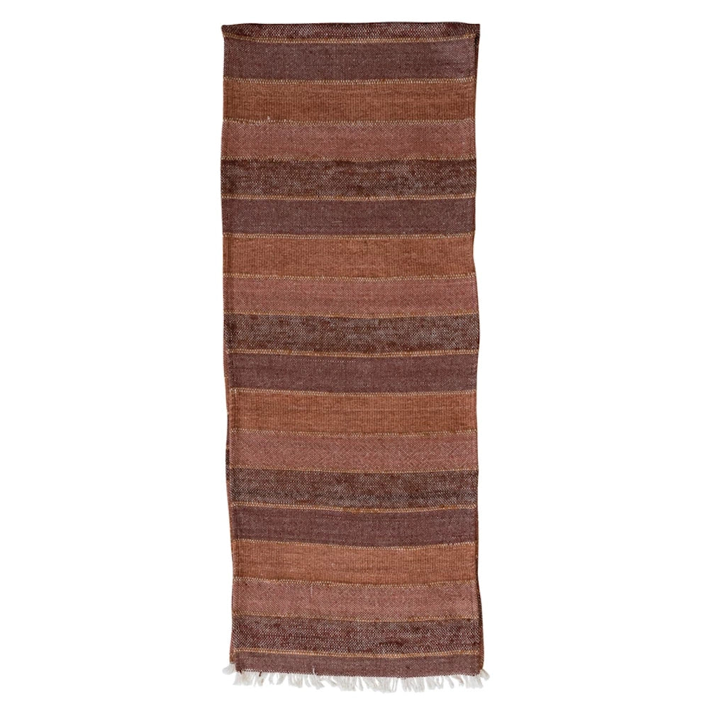 Woven cotton blend striped table runner in earthy brown and terracotta tones with white fringe details.