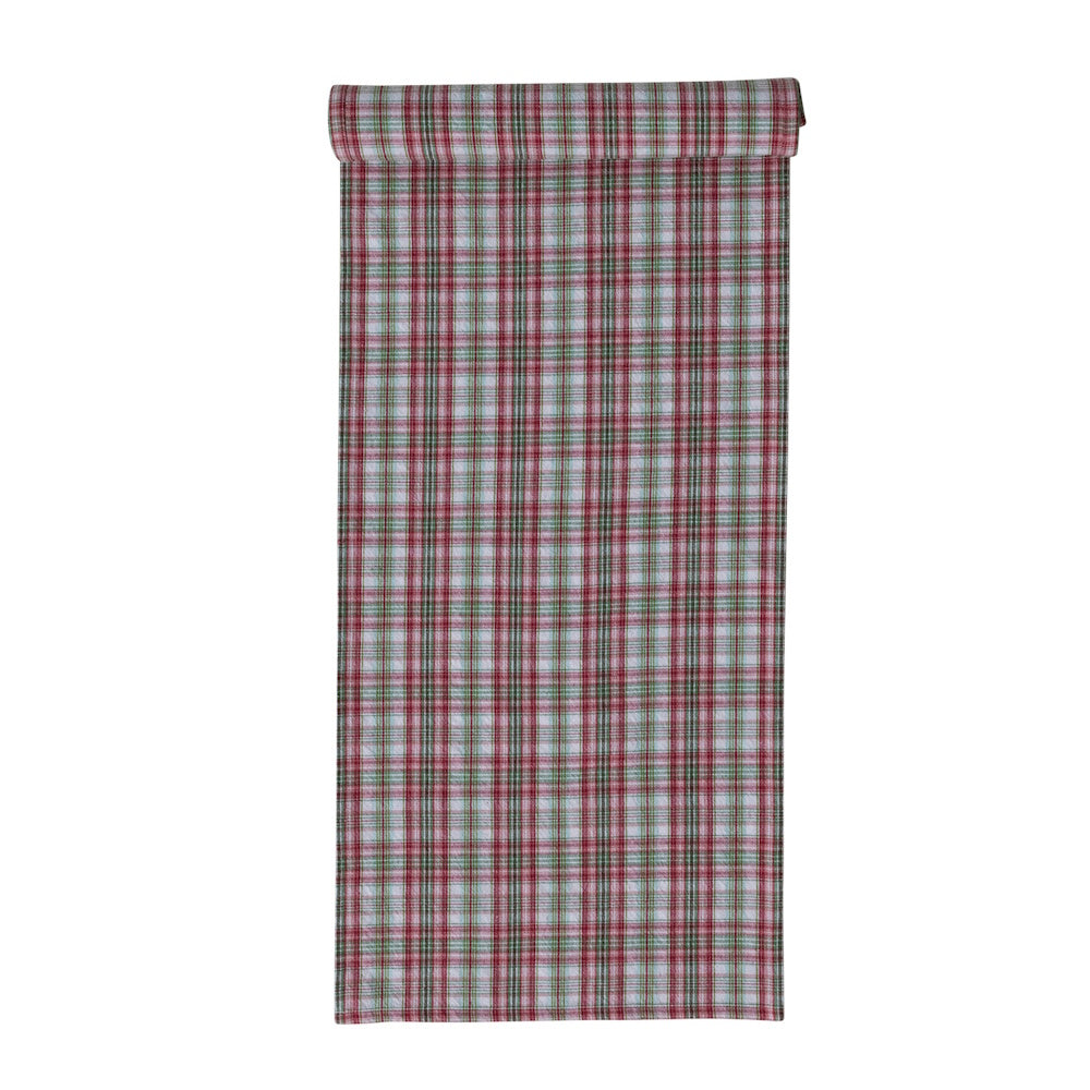 Woven cotton table runner featuring a festive red, green, and white plaid pattern, shown folded at the top against a plain white background.