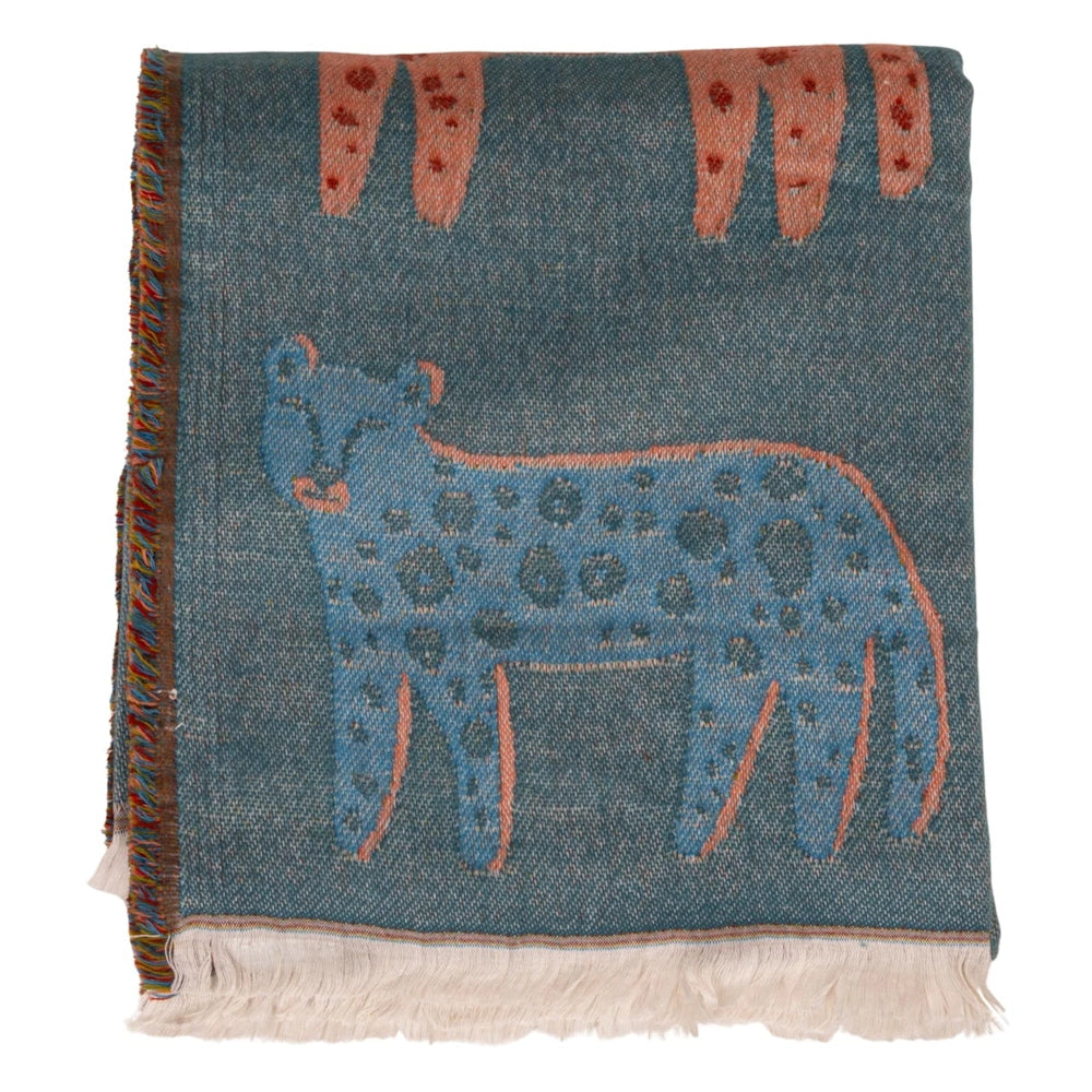 Neatly folded teal woven throw blanket featuring a blue leopard pattern, fringe trim, and colorful side edges.
