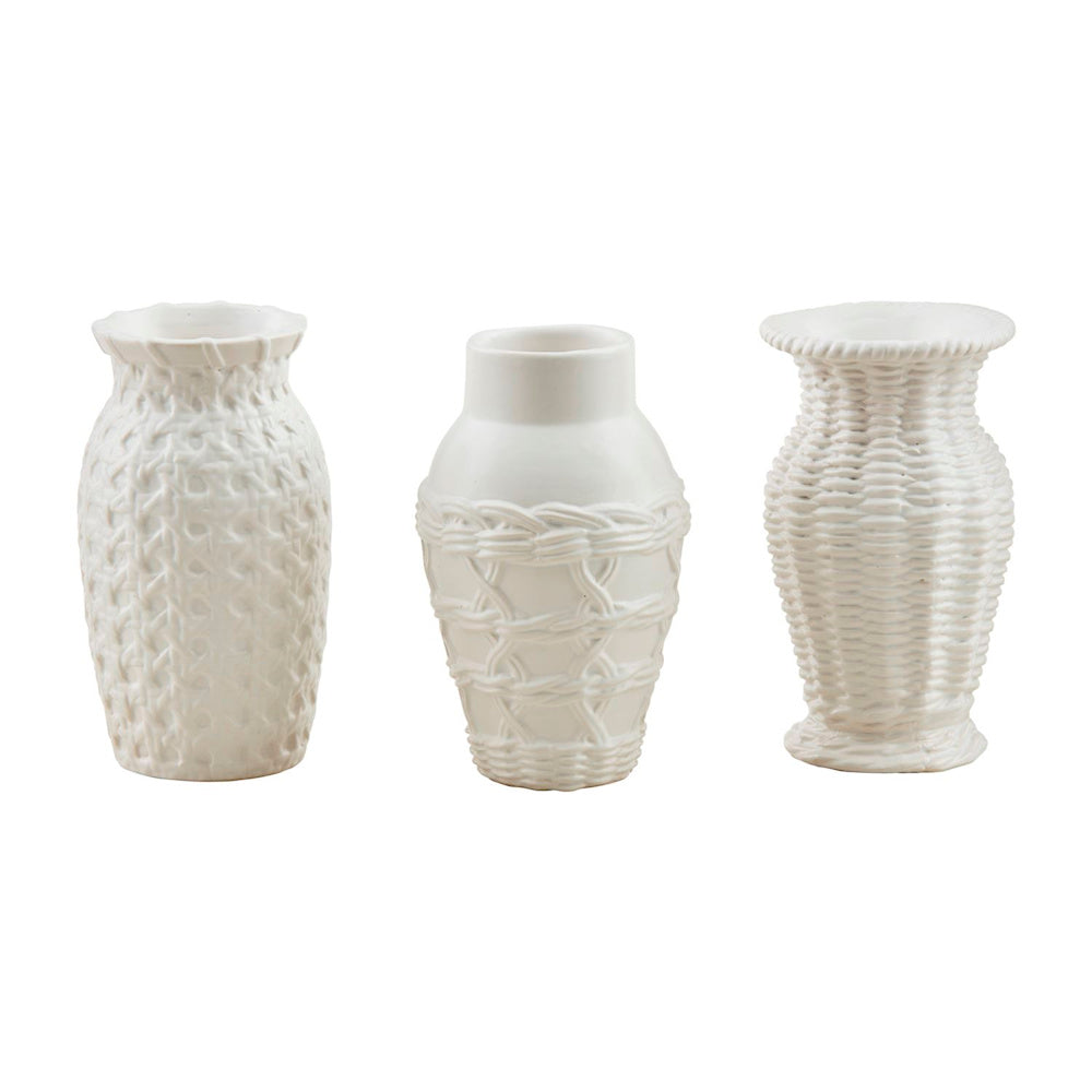 Three white woven stoneware bud vases with various textured basketweave patterns and unique shapes on a white background.