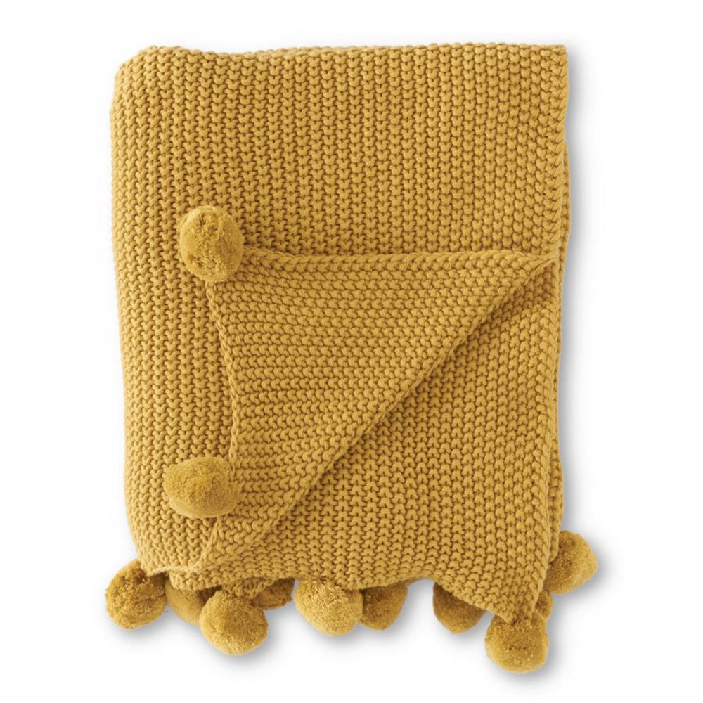 Yellow mustard moss stitch knit throw blanket with pom-pom trim, folded on a white background.