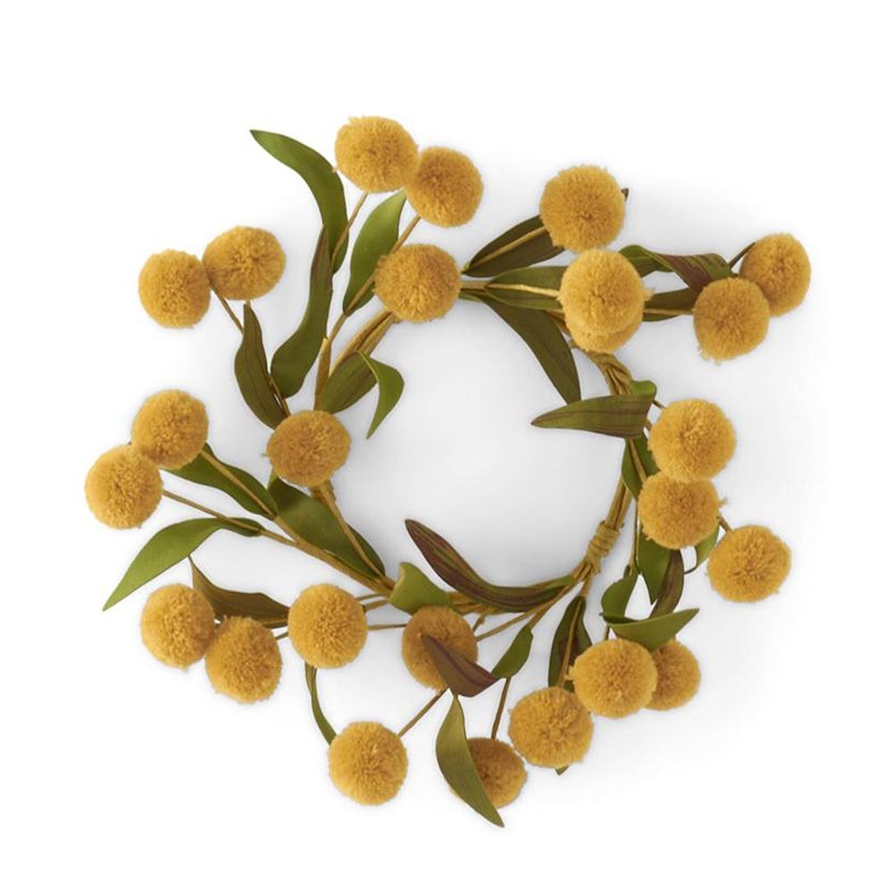 A wreath made of yellow pom-pom flowers and green leaves on a white background.