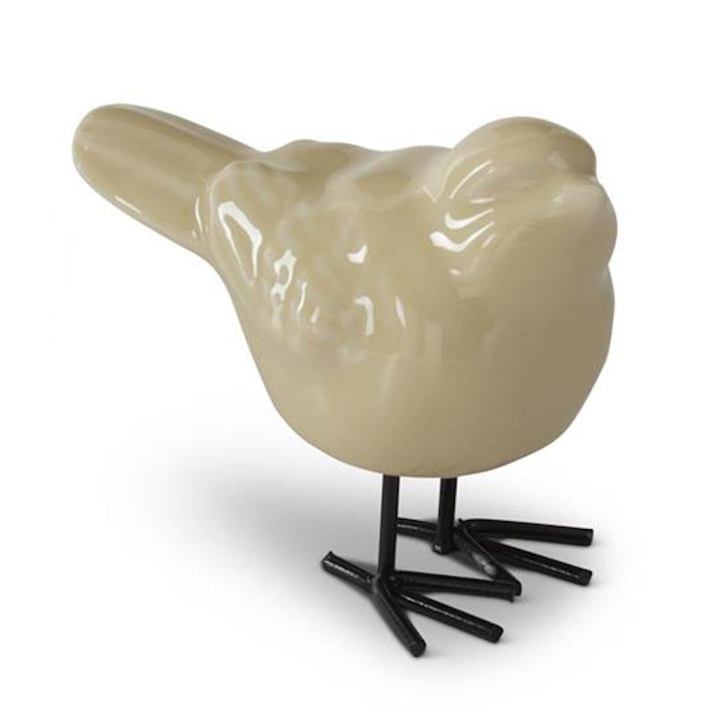 Beige porcelain bird figurine with minimalist black wire legs, isolated on a white background for home decor.
