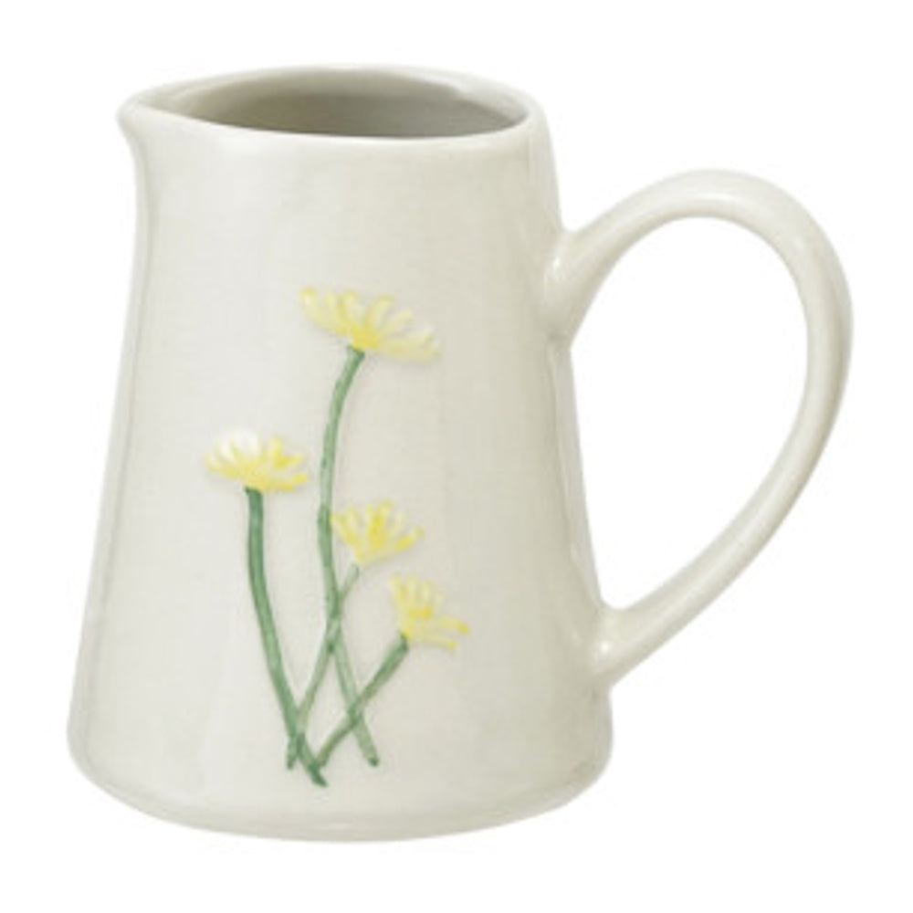 Stoneware creamer featuring an embossed yellow botanical floral design.