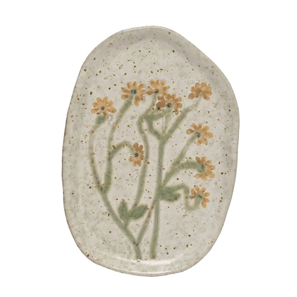 Oval off-white speckled ceramic plate with an organic shape, featuring painted yellow flowers on green stems.
